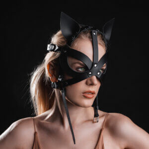 Young lady with black leather Harness Kitty mask